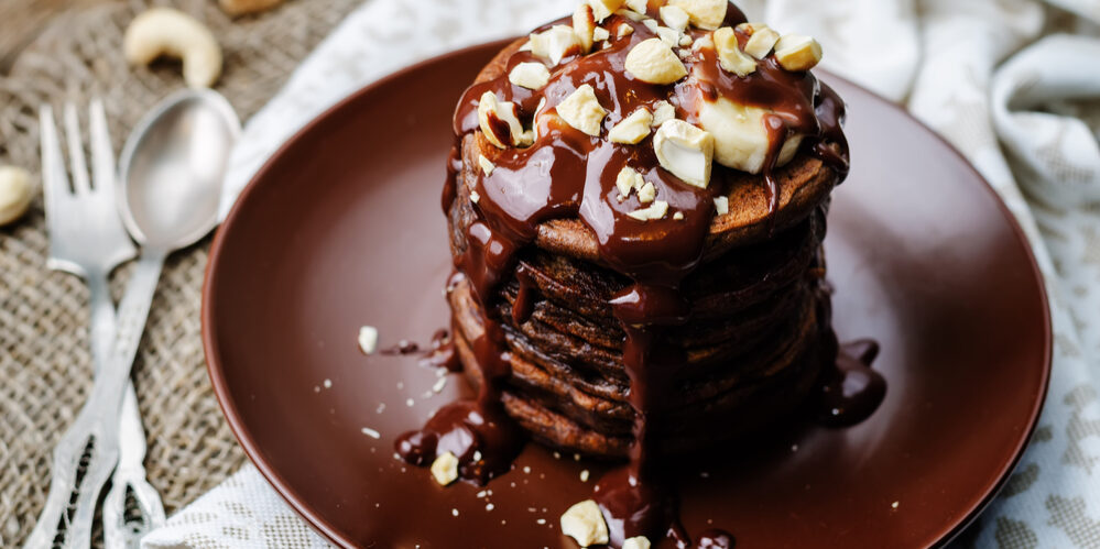 chocolate pancake with bananas, nuts and chocolate sauce. the toning. selective focus